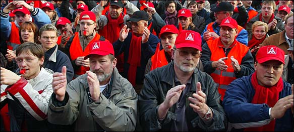 Employees of German car manufacturer Volkswagen AG gather during a warning strike